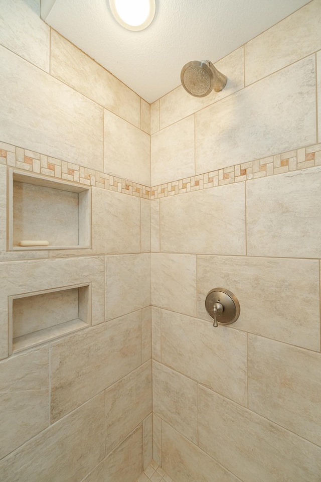 full bathroom with a tile shower