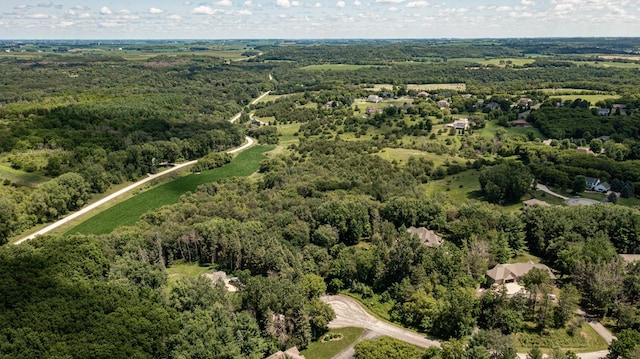 drone / aerial view featuring a forest view