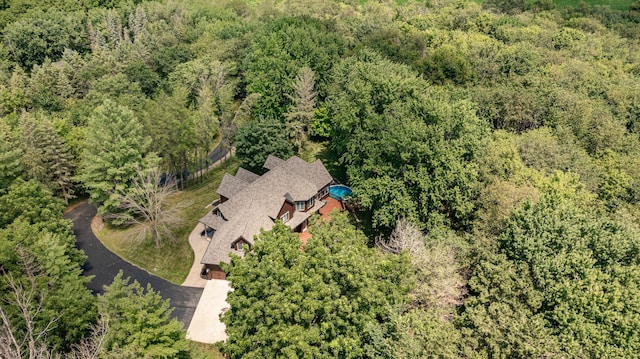 birds eye view of property with a wooded view