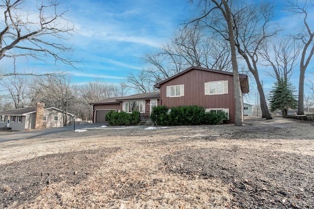 tri-level home featuring driveway and a garage