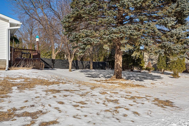 yard layered in snow featuring fence