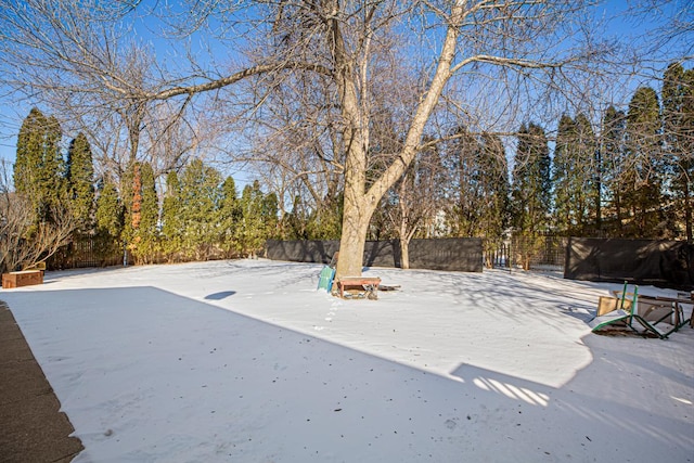 yard covered in snow with fence