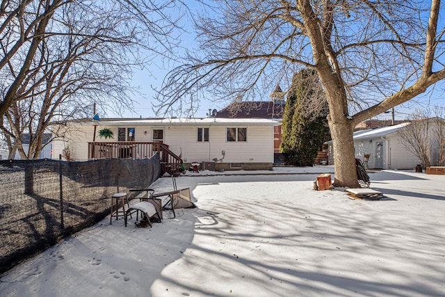 view of snow covered back of property