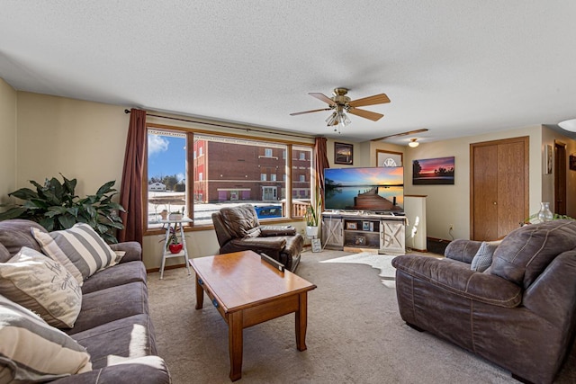 carpeted living room with a ceiling fan and a textured ceiling