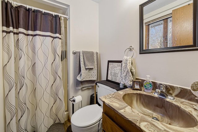 bathroom featuring toilet, a shower with curtain, and vanity