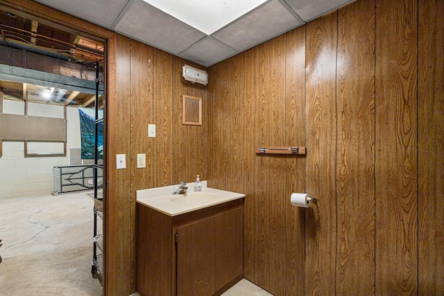 bathroom with wooden walls and vanity