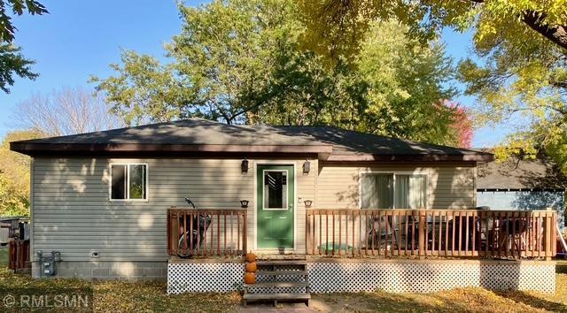 rear view of property featuring a wooden deck