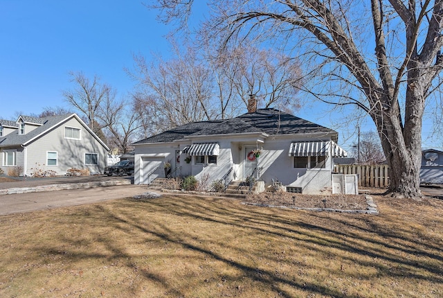 bungalow-style home featuring a chimney, concrete driveway, a front yard, fence, and a garage