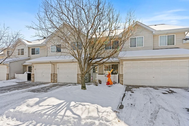 townhome / multi-family property with covered porch and an attached garage