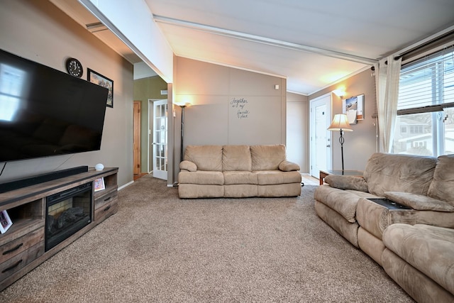 carpeted living area featuring ornamental molding and vaulted ceiling