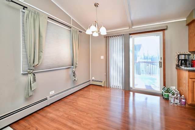 unfurnished room featuring a baseboard heating unit, crown molding, a chandelier, and light wood-style floors