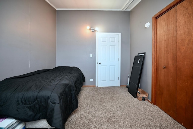 bedroom with carpet floors, ornamental molding, and baseboards