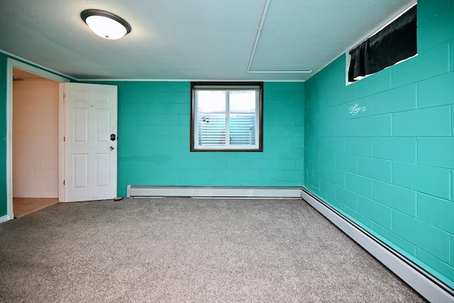 empty room with concrete block wall and baseboard heating