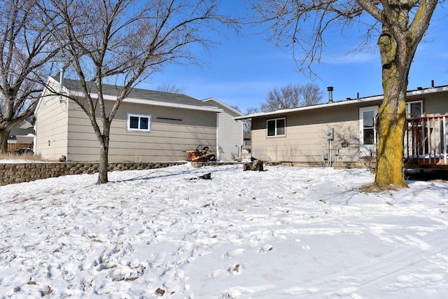 view of snow covered back of property