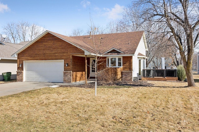 single story home featuring an attached garage, a shingled roof, concrete driveway, and a front yard