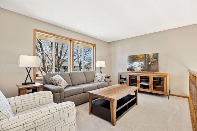 living area with light carpet and baseboards