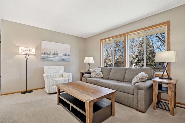 living area featuring light carpet and baseboards