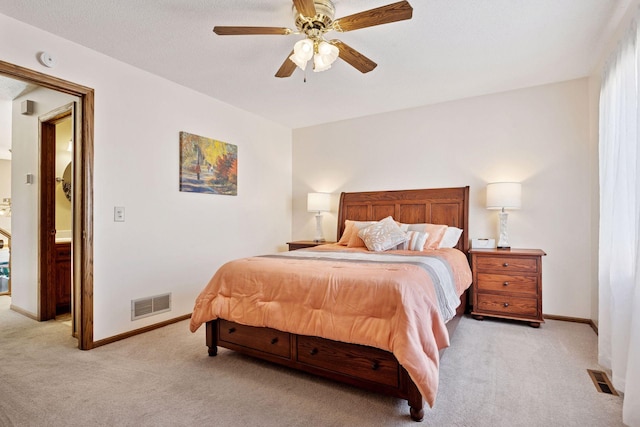 bedroom featuring light colored carpet, visible vents, and baseboards