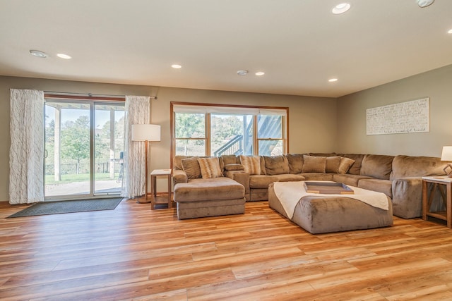 living area featuring light wood-type flooring, a wealth of natural light, and recessed lighting