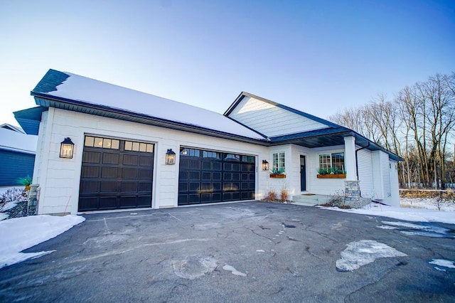 view of front of home with a garage and aphalt driveway