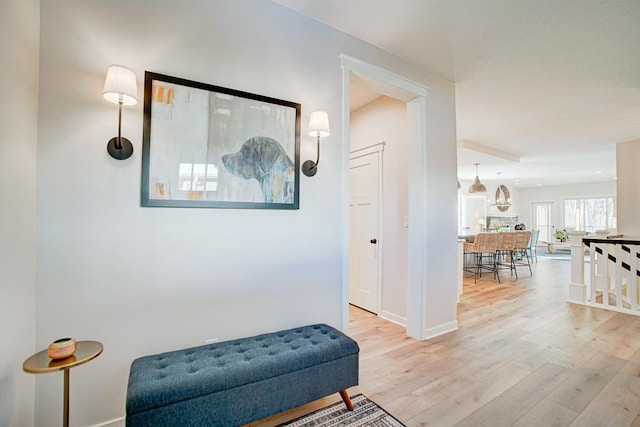 hallway with baseboards and wood finished floors