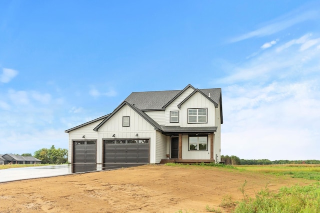 modern inspired farmhouse with driveway, board and batten siding, and roof with shingles