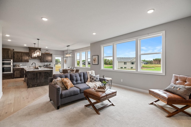 3047X Nicholas St, Grand Rapids, MN 55744 - living area featuring baseboards, a notable chandelier, light colored carpet, and recessed lighting