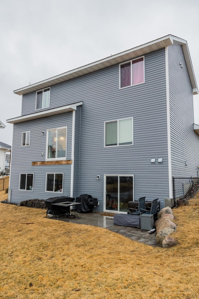 back of house featuring a yard and a patio area