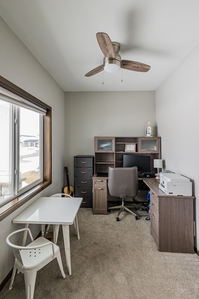 home office featuring light colored carpet and ceiling fan