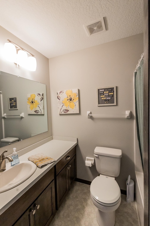 bathroom featuring visible vents, toilet, curtained shower, a textured ceiling, and vanity