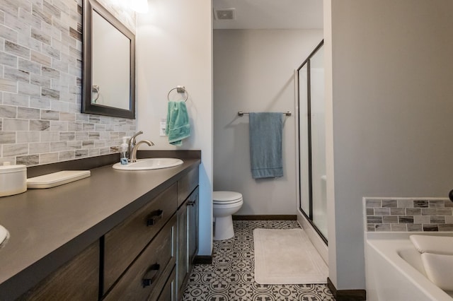 full bathroom with tasteful backsplash, a sink, toilet, and a shower stall