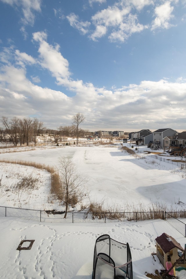 yard layered in snow with a residential view