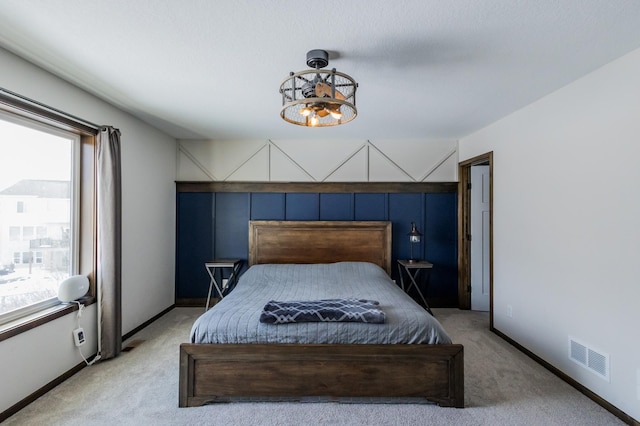 bedroom with a notable chandelier, carpet flooring, visible vents, and baseboards