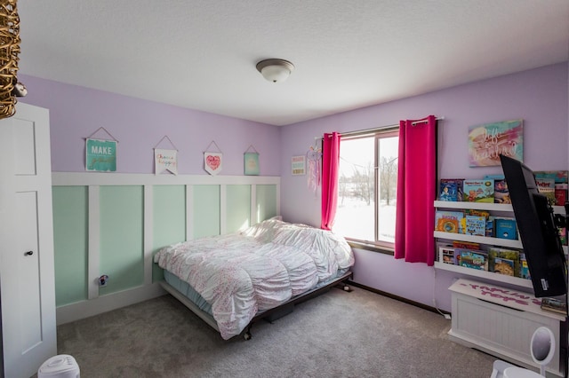 bedroom with carpet floors and baseboards