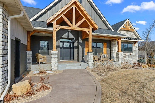 19986 Unity St NW, Oak Grove, MN 55011 - doorway to property with a porch, a shingled roof, board and batten siding, and stone siding