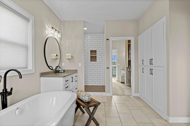 19986 Unity St NW, Oak Grove, MN 55011 - bathroom featuring a freestanding bath, vanity, tile patterned floors, baseboards, and a shower stall