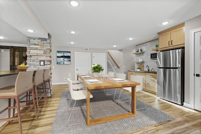 19986 Unity St NW, Oak Grove, MN 55011 - dining space with stairway, baseboards, light wood-style flooring, and visible vents