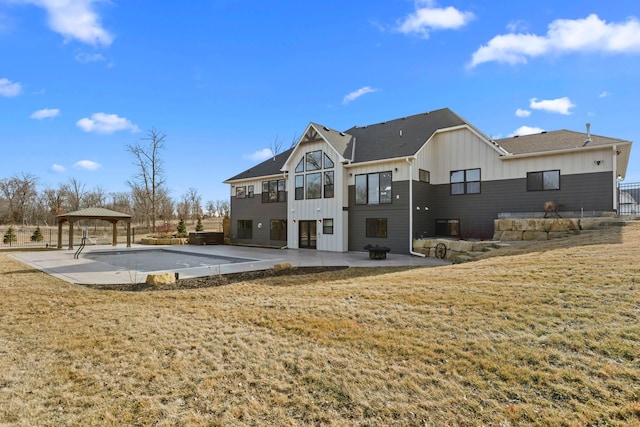 19986 Unity St NW, Oak Grove, MN 55011 - back of house featuring board and batten siding, a patio, a gazebo, and a yard