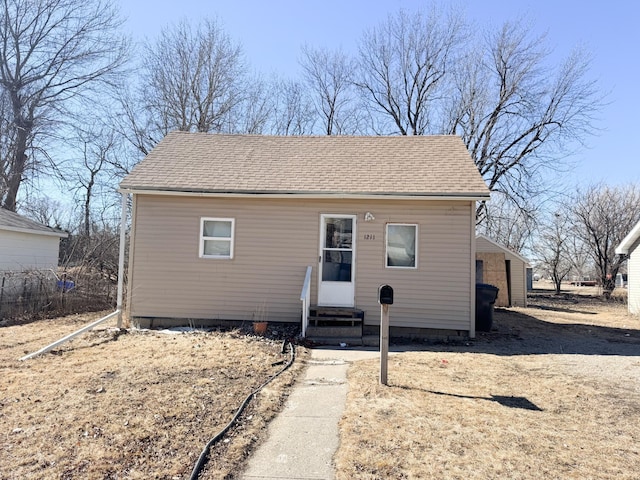 bungalow featuring entry steps and roof with shingles