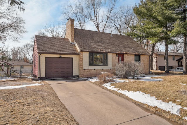 view of front facade with an attached garage, a shingled roof, a chimney, concrete driveway, and brick siding