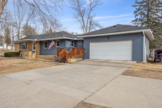 single story home featuring driveway, an attached garage, and a shingled roof