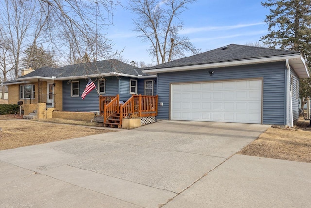 ranch-style home with an attached garage, driveway, and a shingled roof