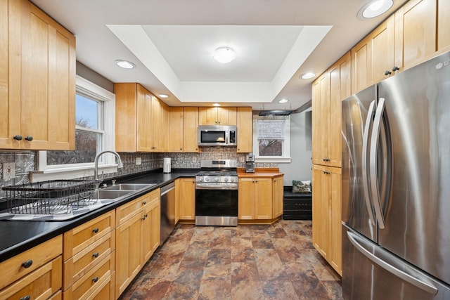 1001 Humboldt Ave W, Saint Paul, MN 55118 - kitchen featuring stainless steel appliances, dark countertops, stone finish floor, and tasteful backsplash