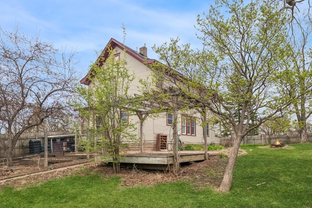 1001 Humboldt Ave W, Saint Paul, MN 55118 - back of house with a chimney, fence, a yard, and a deck