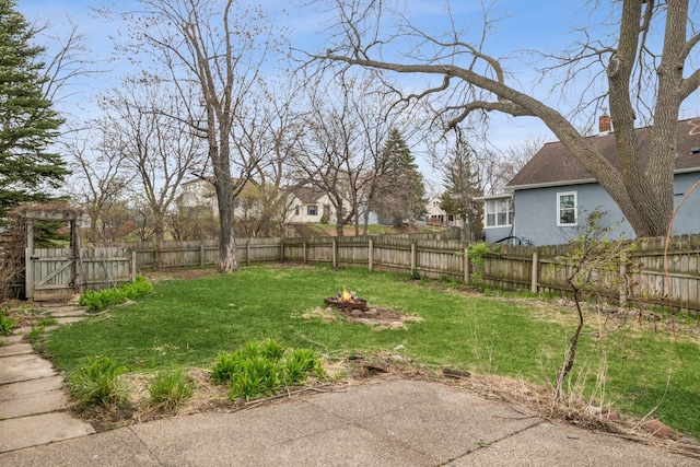 1001 Humboldt Ave W, Saint Paul, MN 55118 - view of yard featuring a fenced backyard, a gate, a fire pit, and a patio area