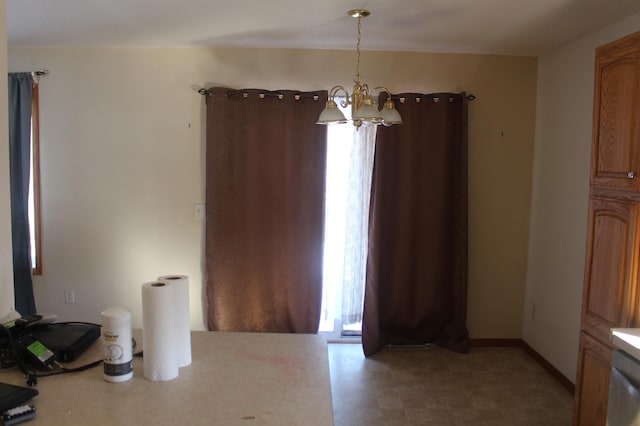 unfurnished dining area featuring baseboards and an inviting chandelier