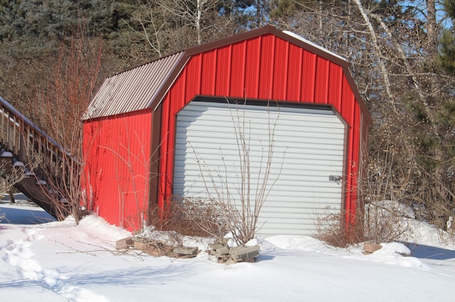 snow covered structure featuring an outdoor structure