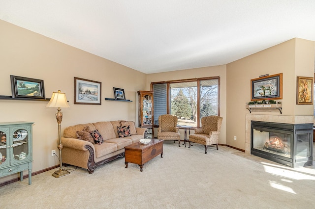 living room with light carpet, a fireplace, and baseboards