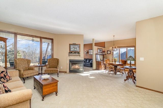 living room featuring light carpet, a fireplace, a chandelier, and baseboards