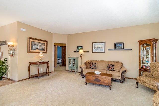 living area featuring light carpet and baseboards